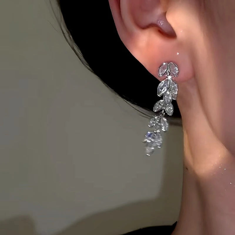 Model showcasing the dangle and style of the 14K Gold-Plated Zircon Wheat Tassel Earrings