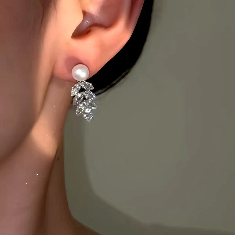 Model showcasing the dangle and style of the 14K Gold-Plated Zircon Wheat Tassel Pearl Earrings