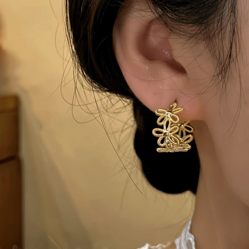 Close-up detail of the sparkling zircons and plating on the Knotted Flower Hoops