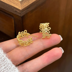 Angled view of the 14K Gold-Plated knot Flower C-Shaped Earrings