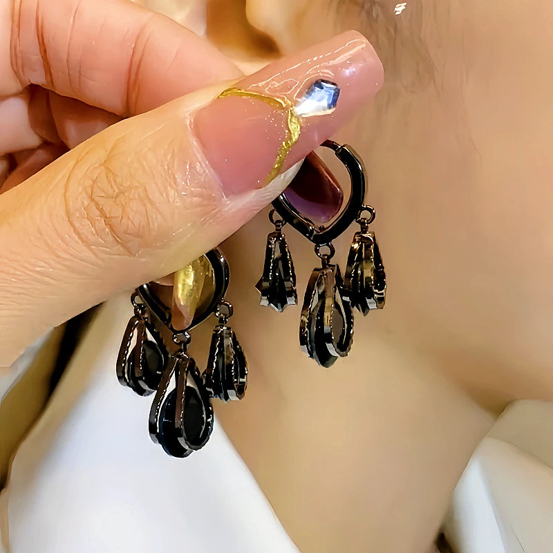 Close-up detail of the sparkling zircons and plating on the gold tassel earrings