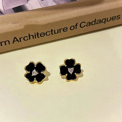 Angled view of the 14K Gold-plated Black Flower Earrings