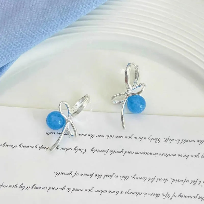 Close-up detail of the sparkling zircons and plating on the Bow Earrings