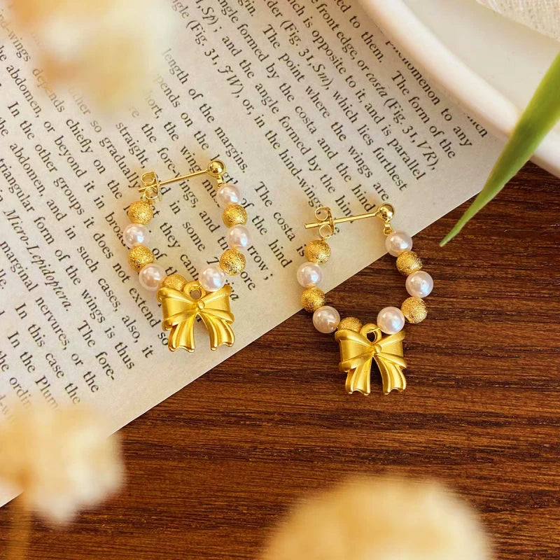 Angled view of the 14K Gold-plated Bow Beaded Earrings