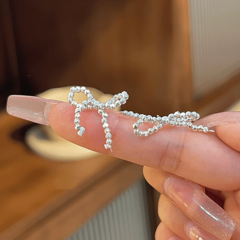 Angled view of the 14K Gold-plated Bow Stud Earrings