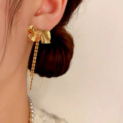 Close-up detail of the sparkling zircons and plating on the Bow Tassel Earrings