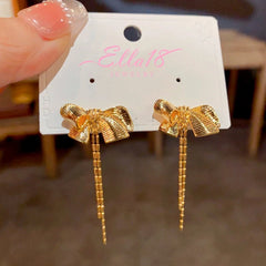 Angled view of the 14K Gold-plated Bow Tassel Earrings