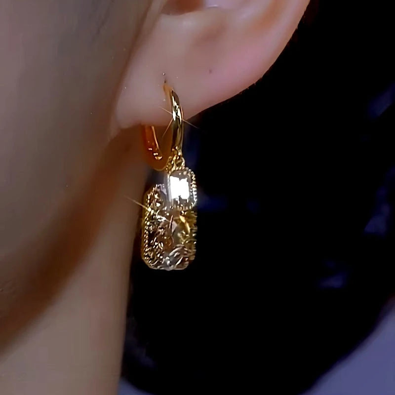 Model showcasing the dangle and style of the 14K Gold-plated Brown Diamond Crystal Square Earrings
