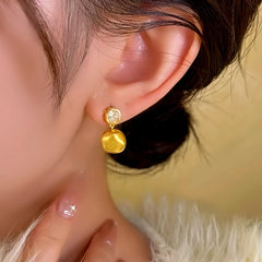 Model showcasing the dangle and style of the 14K Gold-plated Brushed Pendant Small Square Earrings