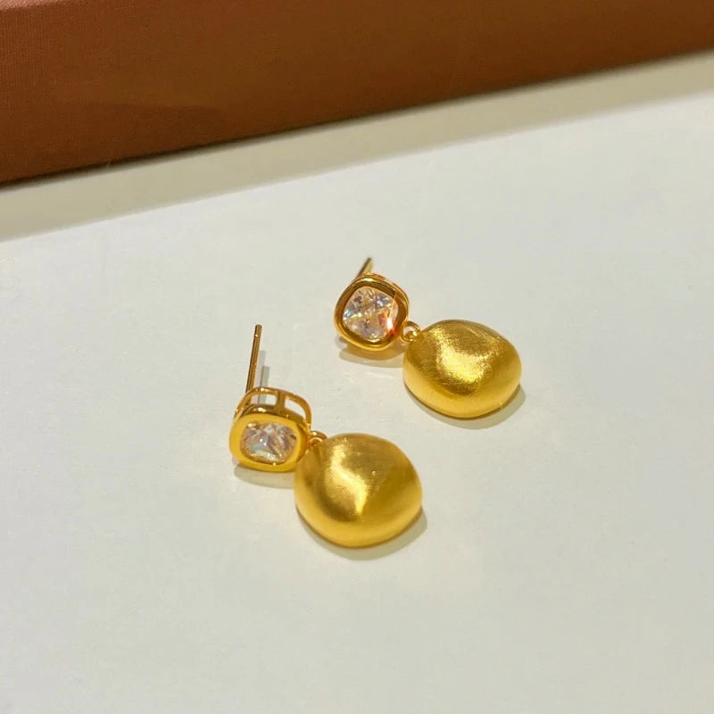 Angled view of the 14K Gold-plated Brushed Pendant Small Square Earrings