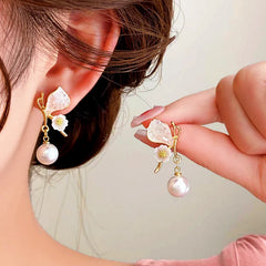 Model showcasing the dangle and style of the 14K Gold-plated Butterfly Pearl Earrings