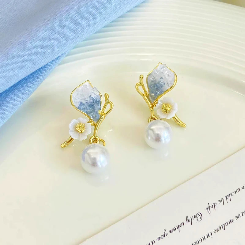 Close-up detail of the sparkling zircons and plating on the Butterfly Pearl Earrings