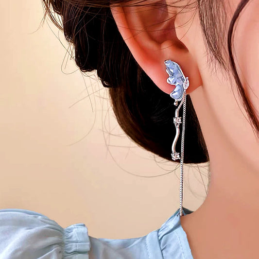 Model showcasing the dangle and style of the 14K Gold-plated Butterfly Tassel Earrings