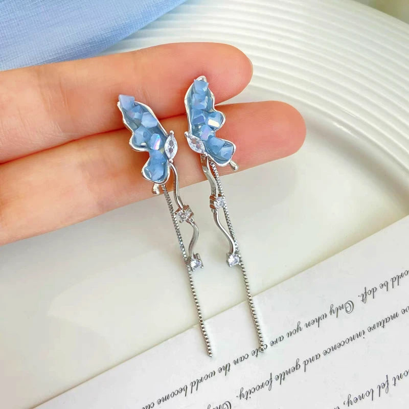 Angled view of the 14K Gold-plated Butterfly Tassel Earrings