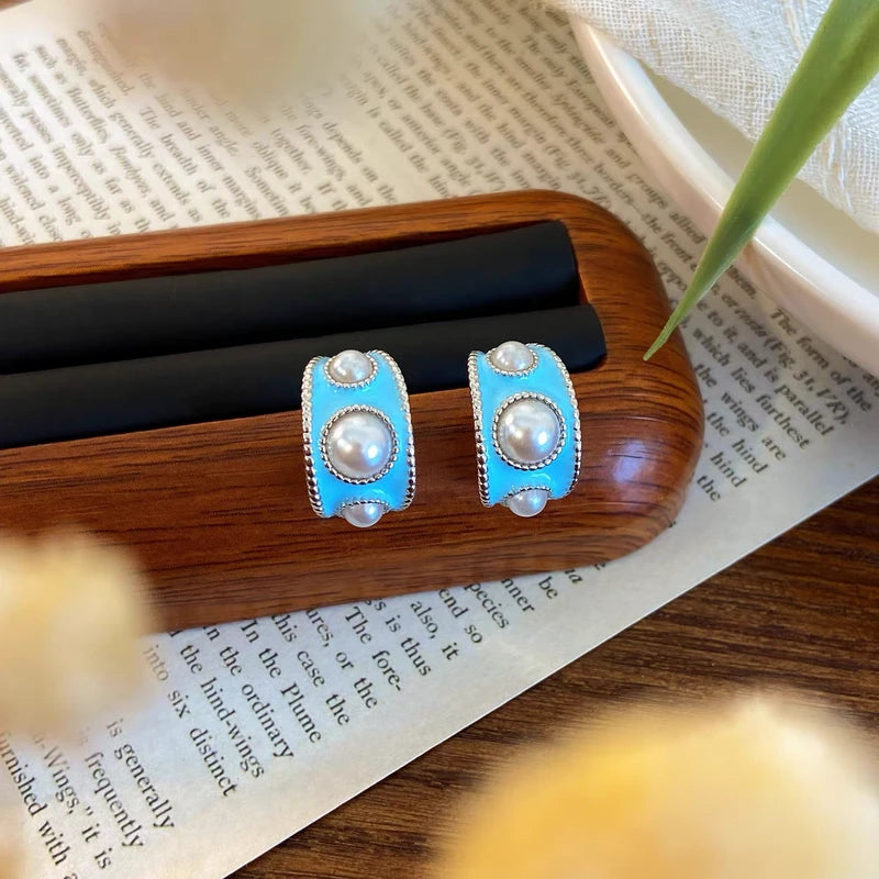 Angled view of the 14K Gold-plated C-Shaped Pearl Earrings