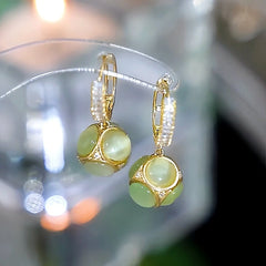 Close-up detail of the sparkling zircons and plating on the Cat's Eye Drop Earrings