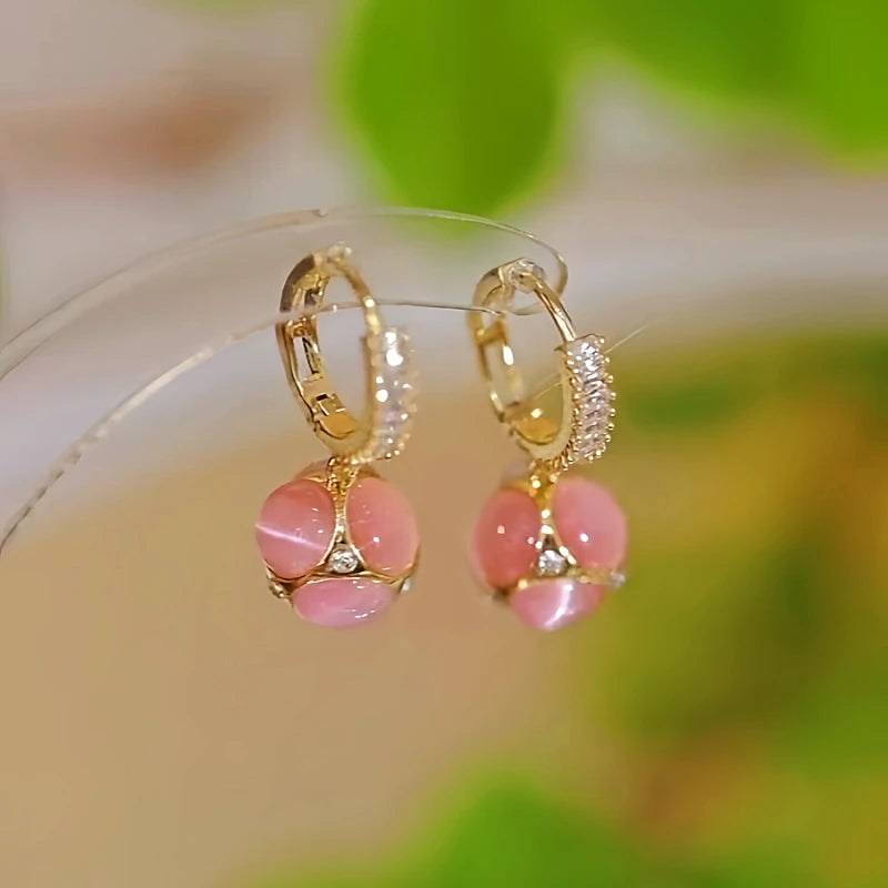 Angled view of the 14K Gold-plated Cat's Eye Pink And Green Drop Earrings