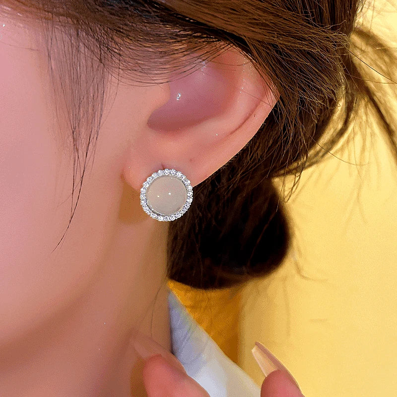 Model showcasing the dangle and style of the 14K Gold-plated Cat's Eye Stud Earrings