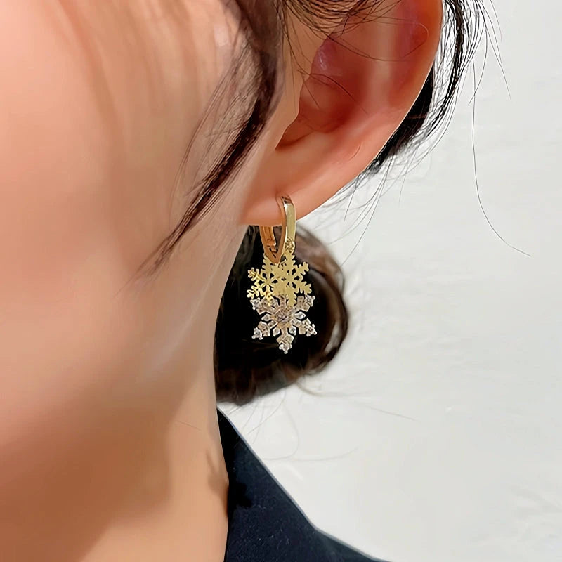 Model showcasing the dangle and style of the 14K Gold-plated Christmas Diamond Zircon Snowflake Earrings