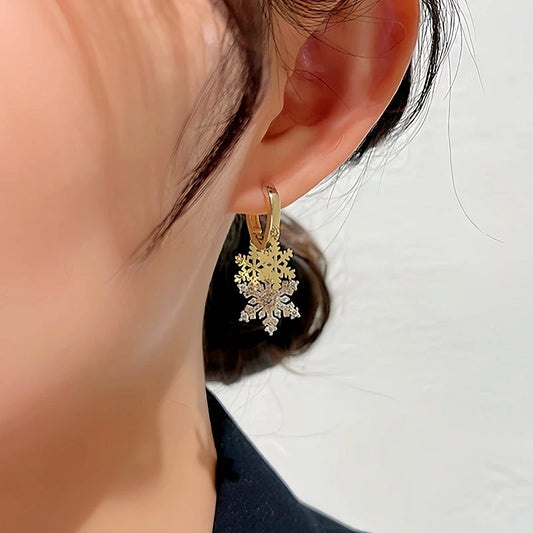 Model showcasing the dangle and style of the 14K Gold-plated Christmas Diamond Zircon Snowflake Earrings