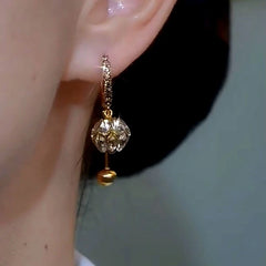 Close-up detail of the sparkling zircons and plating on the Golden Diamond Ball Earrings
