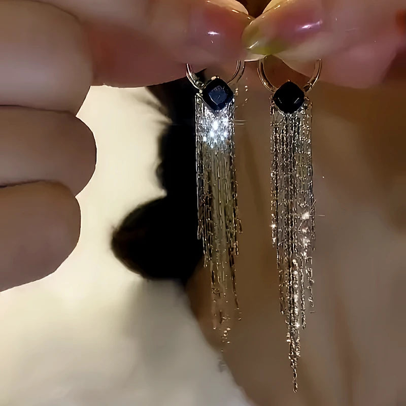 Model showcasing the dangle and style of the 14K Gold-plated Diamond Geometric Tassel Earrings