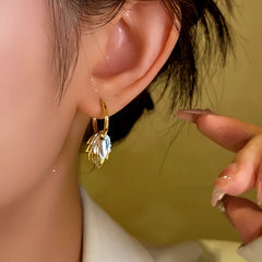 Model showcasing the dangle and style of the 14K Gold-plated Double Leaf Earrings
