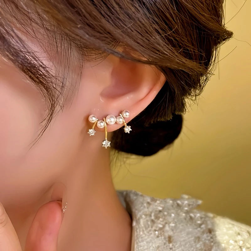 Model showcasing the dangle and style of the 14K Gold-plated Dreamy Meteor Bead Earrings