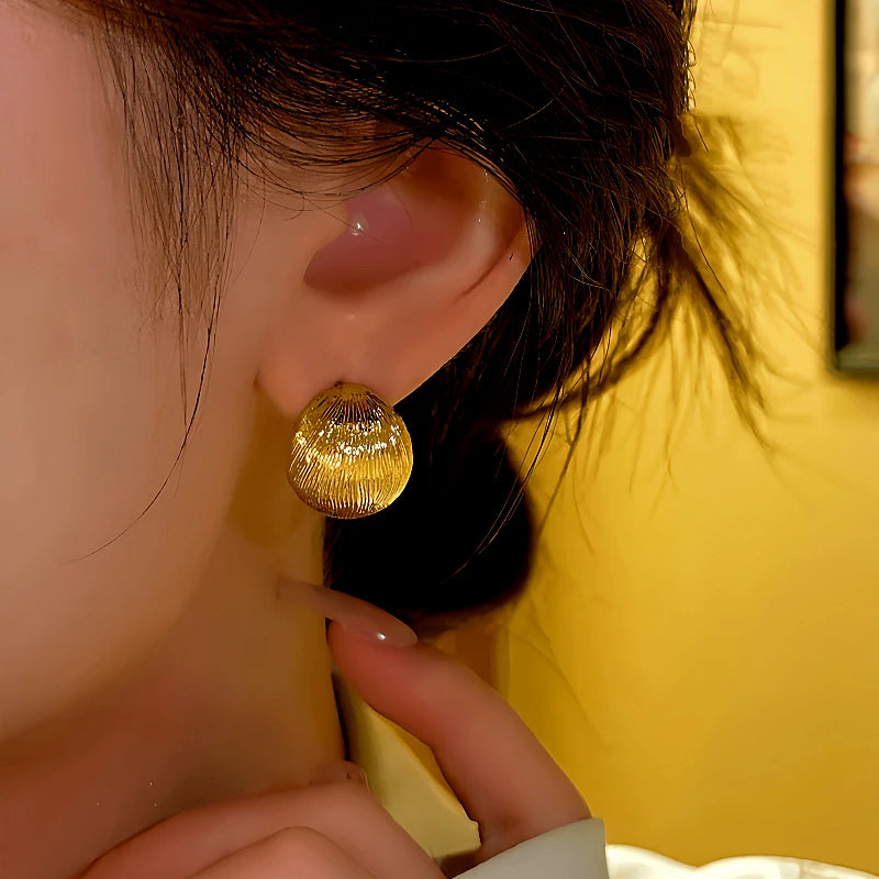 Model showcasing the dangle and style of the 14K Gold-plated Elegant Brushed C-Shaped Earrings