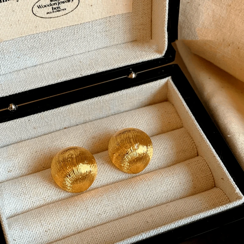 Close-up detail of the sparkling zircons and plating on the Brushed C-Shaped Earrings