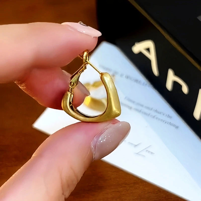 Close-up detail of the sparkling zircons and plating on the Brushed Heart Earrings