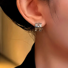 Close-up detail of the sparkling zircons and plating on the H Letter Earrings