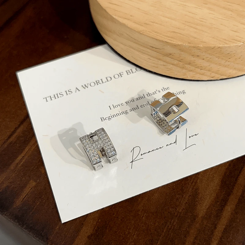 Angled view of the 14K Gold-plated Elegant Double-Sided H Letter Earrings