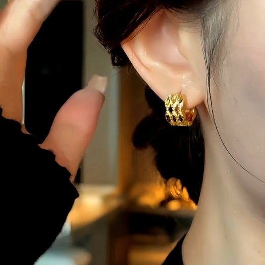 Model showcasing the dangle and style of the 14K Gold-plated Elegant Three-Layer Hoop Earrings