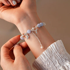 Model wearing the 14K Gold-plated Exquisite Cat's Eye Aquamarine Pearl Beaded Bracelets to highlight its design on the wrist