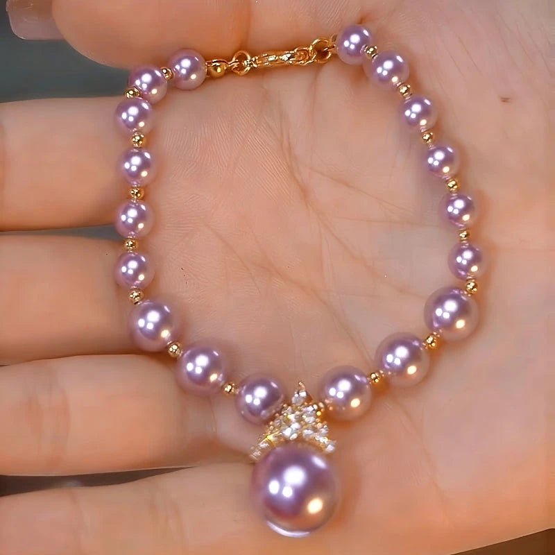 Model wearing the 14K Gold-plated Exquisite Diamond Purple Pearl Bracelet to highlight its design on the wrist