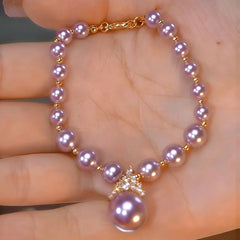 Model wearing the 14K Gold-plated Exquisite Diamond Purple Pearl Bracelet to highlight its design on the wrist
