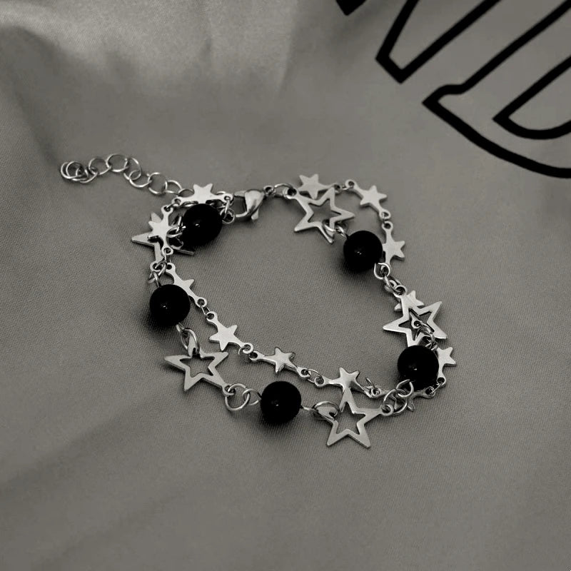 Model wearing the 14K Gold-plated Exquisite Hollow Five-Pointed Star Clavicle Bracelet to highlight its design on the wrist