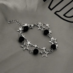 Model wearing the 14K Gold-plated Exquisite Hollow Five-Pointed Star Clavicle Bracelet to highlight its design on the wrist