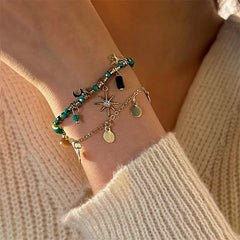 Model wearing the 14K Gold-plated Exquisite Star And Moon Beaded Bracelet to highlight its design on the wrist