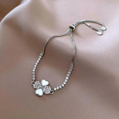 Close-up of the clasp and charm details on the Four-Leaf Bracelets