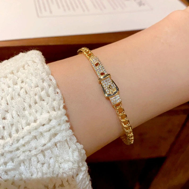 Model wearing the 14K Gold-plated Exquisite Zircon Belt Buckle Hollow Bracelets to highlight its design on the wrist