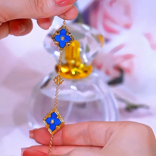 Model wearing the 14K Gold-plated Exquisite Zircon Blue Shell Four-Leaf Clover Double-Sided Bracelets to highlight its design on the wrist
