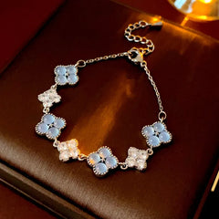 Model wearing the 14K Gold-plated Exquisite Zircon Cat's Eye Stone Four-Leaf Bracelets to highlight its design on the wrist