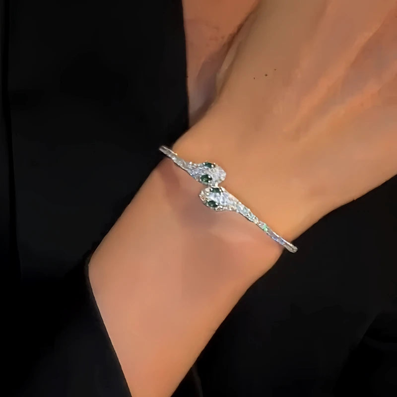 Close-up of the clasp and charm details on the Double Snake Bracelets