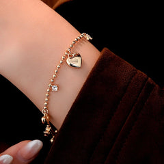 Close-up of the clasp and charm details on the Zircon Heart Bracelets