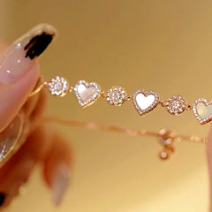 Model wearing the 14K Gold-plated Exquisite Zircon Sun Heart Pull-Out Bracelet to highlight its design on the wrist