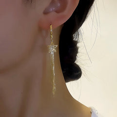 Model showcasing the dangle and style of the 14K Gold-plated Five-Pointed Star Earrings