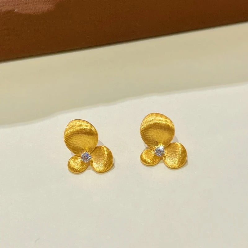 Angled view of the 14K Gold-plated Flower Stud Earrings