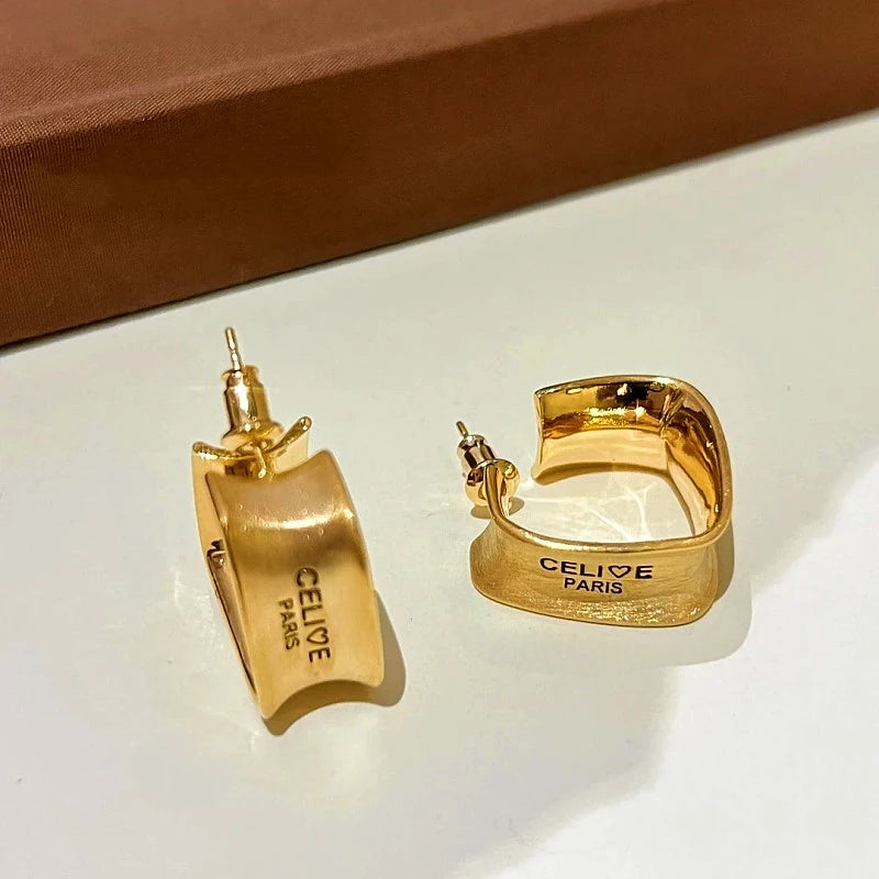 Close-up detail of the sparkling zircons and plating on the Brushed Letter Earrings